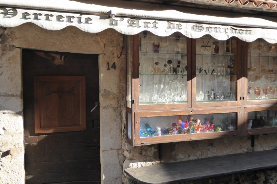 Shopfront of the Verrerie d'Art de Gourdon and its blown-glass display cases