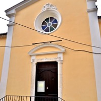 Yellow façade of the Église Notre-Dame-des-Neiges in Sainte-Agnès